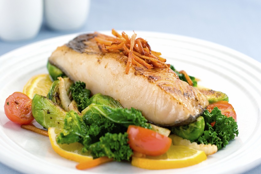 A delicious filet of rich Black Cod served atop braised brussel sprouts, kale, fennel and tomato. Shallow dof.