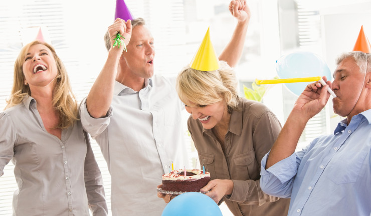 Casual business people celebrating birthday and having fun in the office