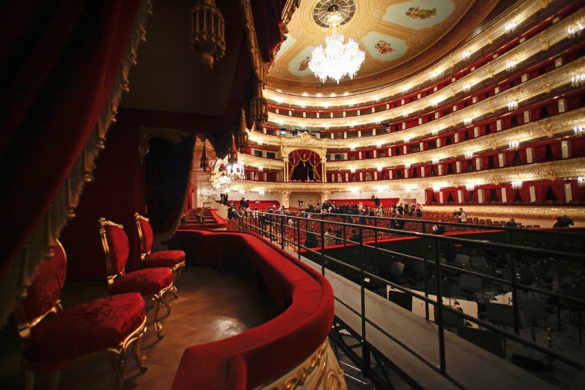 Members of the media gather in the main hall of the Bolshoi Theater during a press tour organized by the theater's restorers, in Moscow, Russia, Saturday, Oct. 8, 2011. The historic building is expected to reopen on Oct. 28 after undergoing extensive renovation work. (AP Photo/Alexander Zemlianichenko)