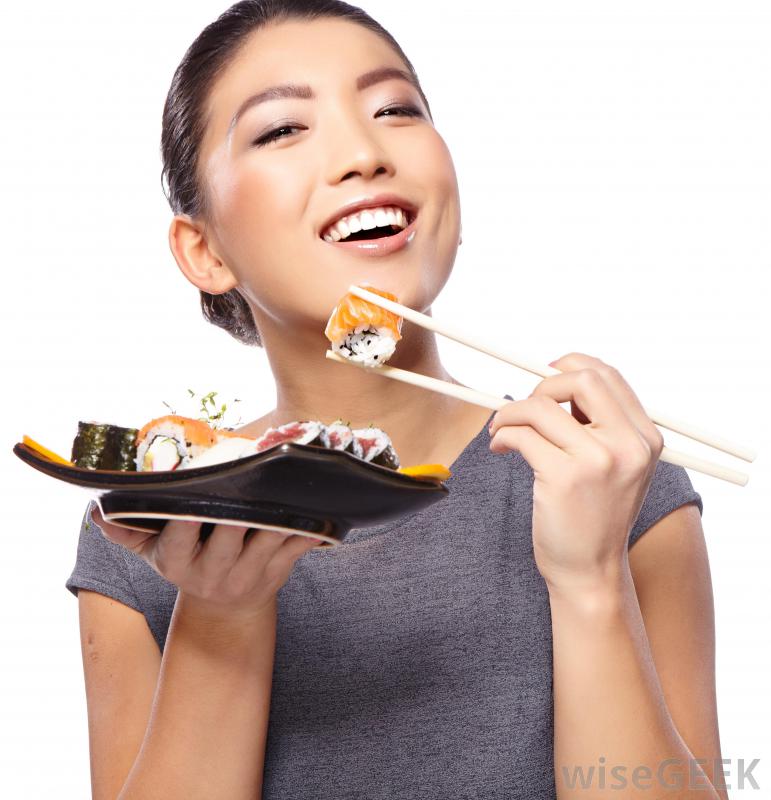 woman-in-gray-eating-sushi-with-chopsticks