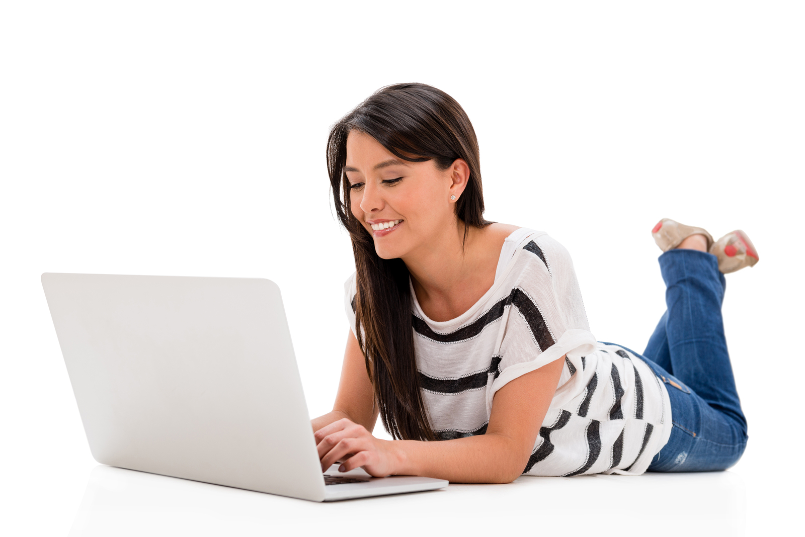 Happy woman working on a laptop computer - isolated over white background
